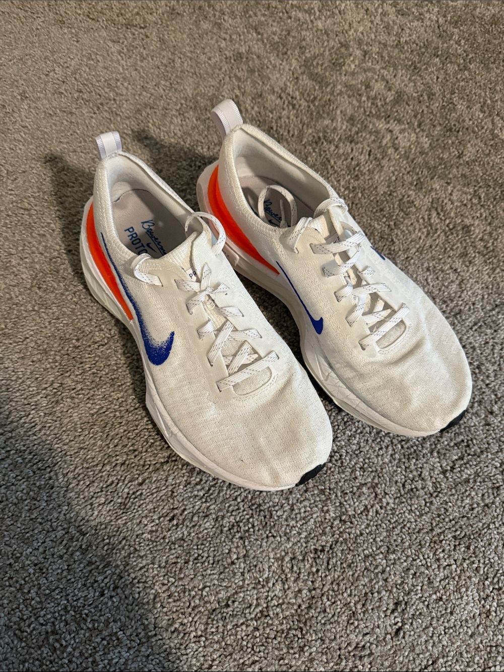 Nike Kids White Sneakers with Blue Swoosh and Orange Heel Accent - Picture 2 of 2